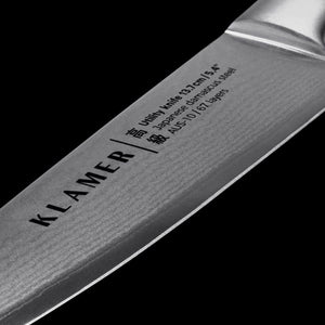 Damast Allzweckmesser 13.7cm blade detail showing Japanese Damascus steel and brand engraving.