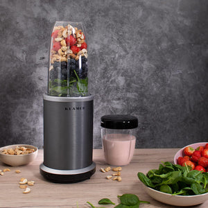 Bullet Mixer with fruits, nuts, and spinach for smoothie preparation on a kitchen counter.